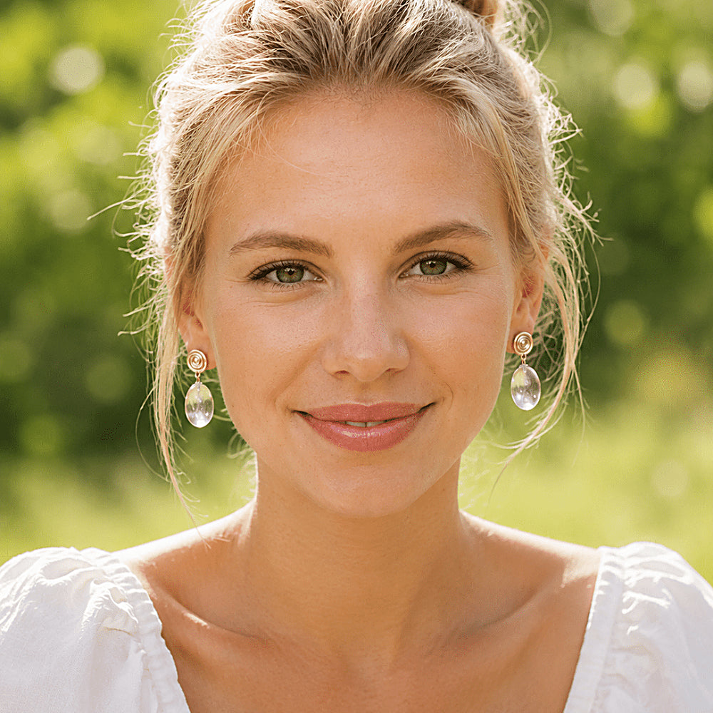 Discover the Vortex Clear Quartz Crystal Spiral Earrings at The Luxe Maison, featuring sculptural spiral studs and luminous clear quartz drops for a modern, elegant look inspired by balance and natural movement.