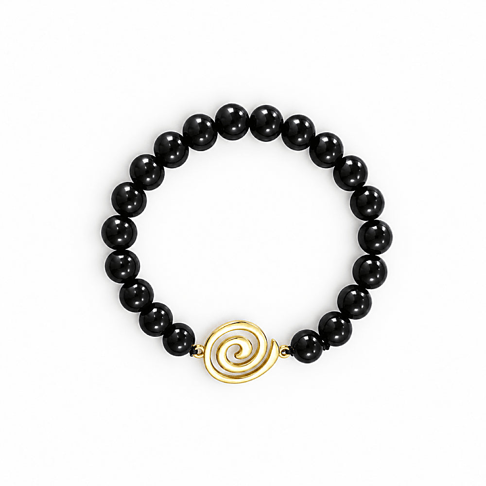 Discover the Vortex Shungite EMF Protection Bracelet at The Luxe Maison, featuring polished black shungite beads and a golden spiral charm.