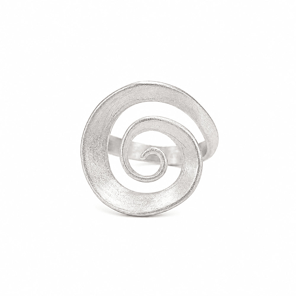 Discover the Vortex Sterling Silver Spiral Ring at The Luxe Maison, featuring a sculptural spiral design and a softly matte sterling silver finish. Inspired by the flowing forms of nature and the cosmos, this adjustable statement ring combines contemporary elegance with organic movement, making it perfect for everyday wear and special occasions.