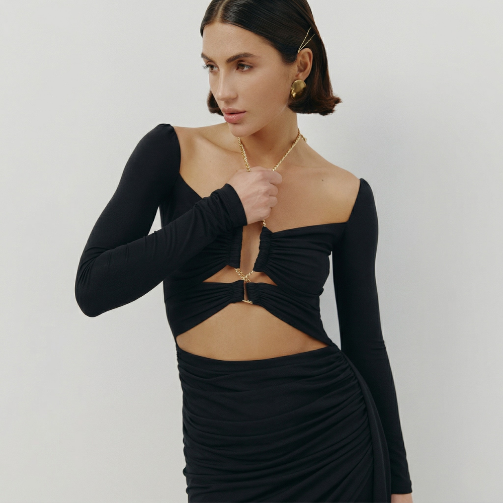 Perfectly fitted knit dress with a gold chain detail and elegant leg-length train. Shop now at our exclusive clothing website.