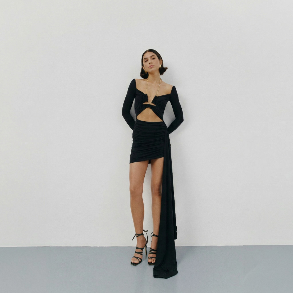 Perfectly fitted knit dress with a gold chain detail and elegant leg-length train. Shop now at our exclusive clothing website.