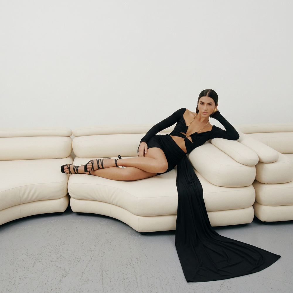 Perfectly fitted knit dress with a gold chain detail and elegant leg-length train. Shop now at our exclusive clothing website.