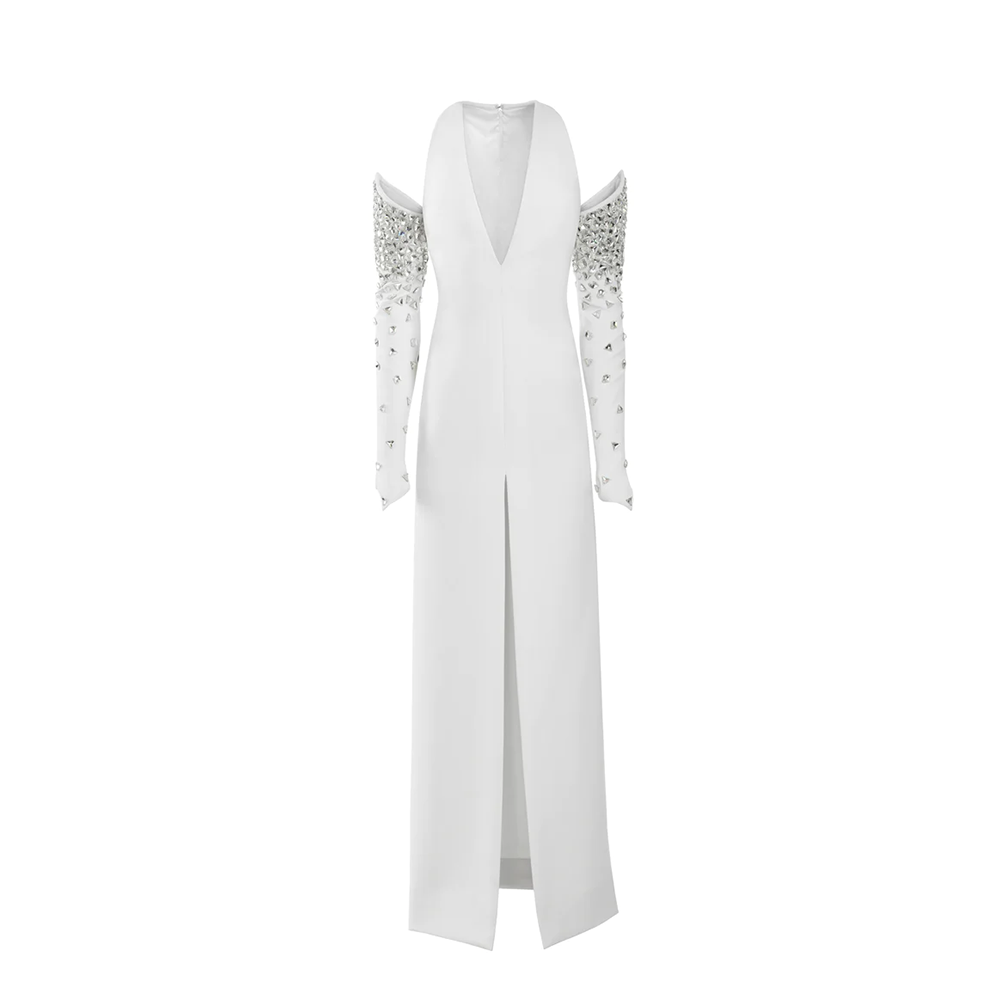 A white silk crepe dress with a center front slit and crystal embroidered structured sleeves.