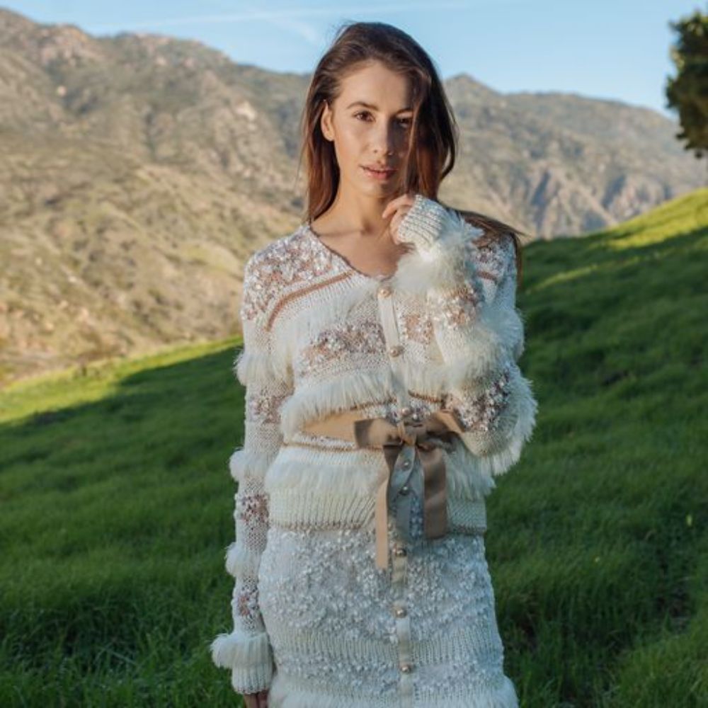 White Sundown Handmade Knit Skirt with pearl buttons on the front looks like a piece of art. 