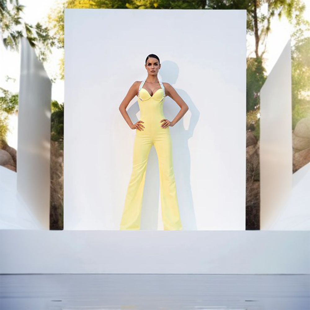 A canary yellow crepe corseted jumpsuit with crystal embroidered straps.