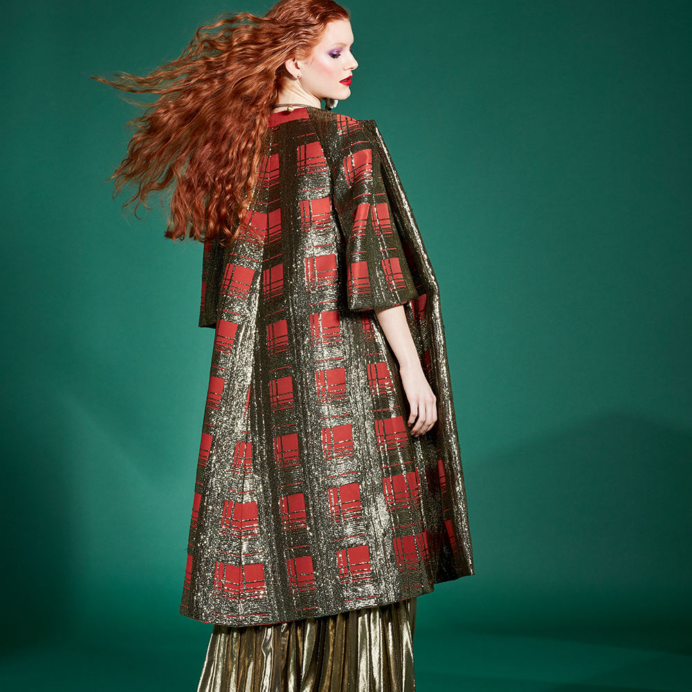 This yolancris piece is a pollet embroidered silk coat that draws a striking copper and dark gold prince of wales print.