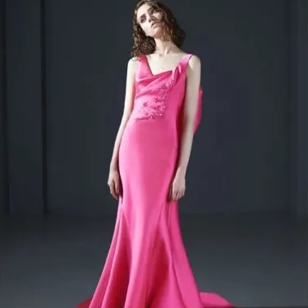 Mermaid gown in silk mikado with asymmetric neckline and hand beaded bodice. 