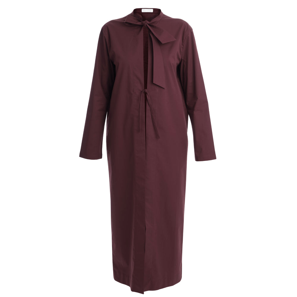 Discover the Zen Coat at The Luxe Maison, featuring a lightweight, unlined design, stand-up collar, tie fastening, bell sleeves, and a slim calf-length silhouette.