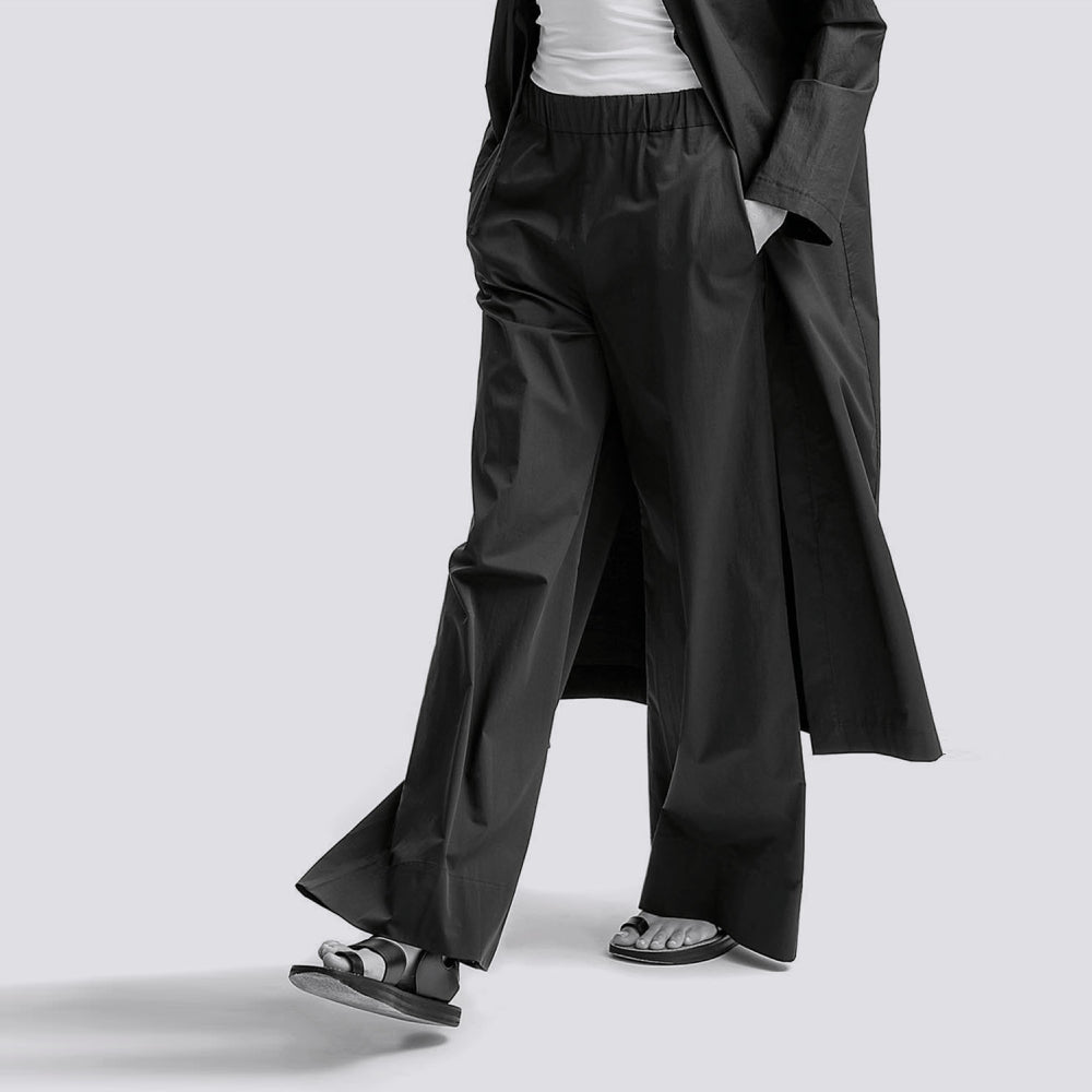 Discover the Zen Pants at The Luxe Maison, featuring a wide palazzo silhouette, elastic waistband, and side pockets for effortless comfort and versatile styling.