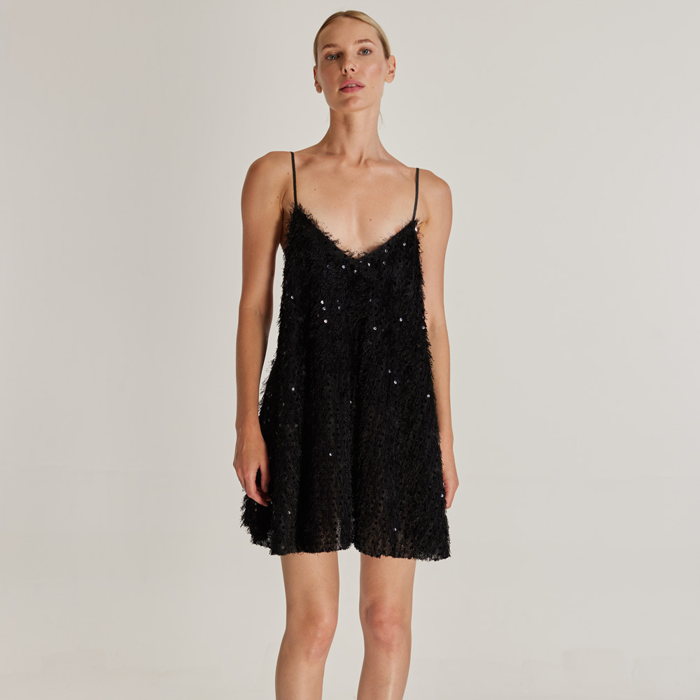 The Zephyr Dress is a stunning, sequined and tasseled black mini dress with a deep open back.