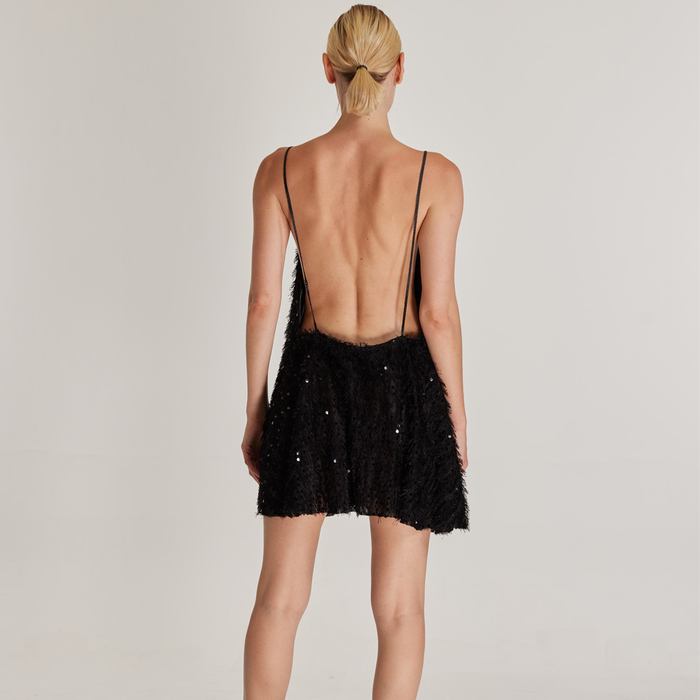 The Zephyr Dress is a stunning, sequined and tasseled black mini dress with a deep open back.