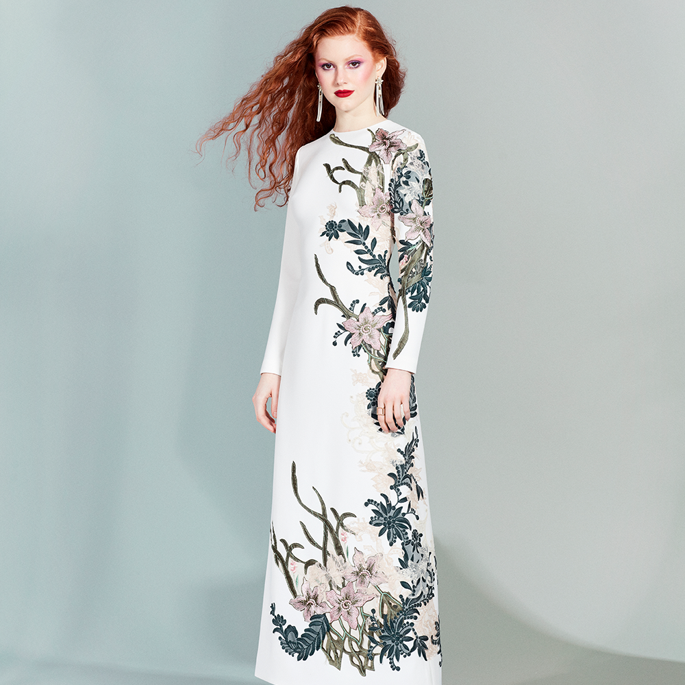 Long-sleeved ankle-length dress made of white crepe embroidered with velvet, guipure and lace in shades of green and pink.