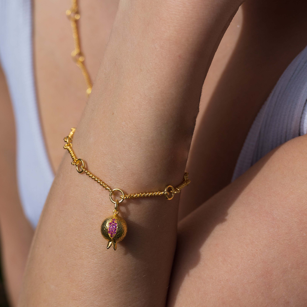 The Pomona Bracelet is inspired by historical gold manufacturing technique. Adorned with red garnet, from our curation of women's jewellery. Shop now!